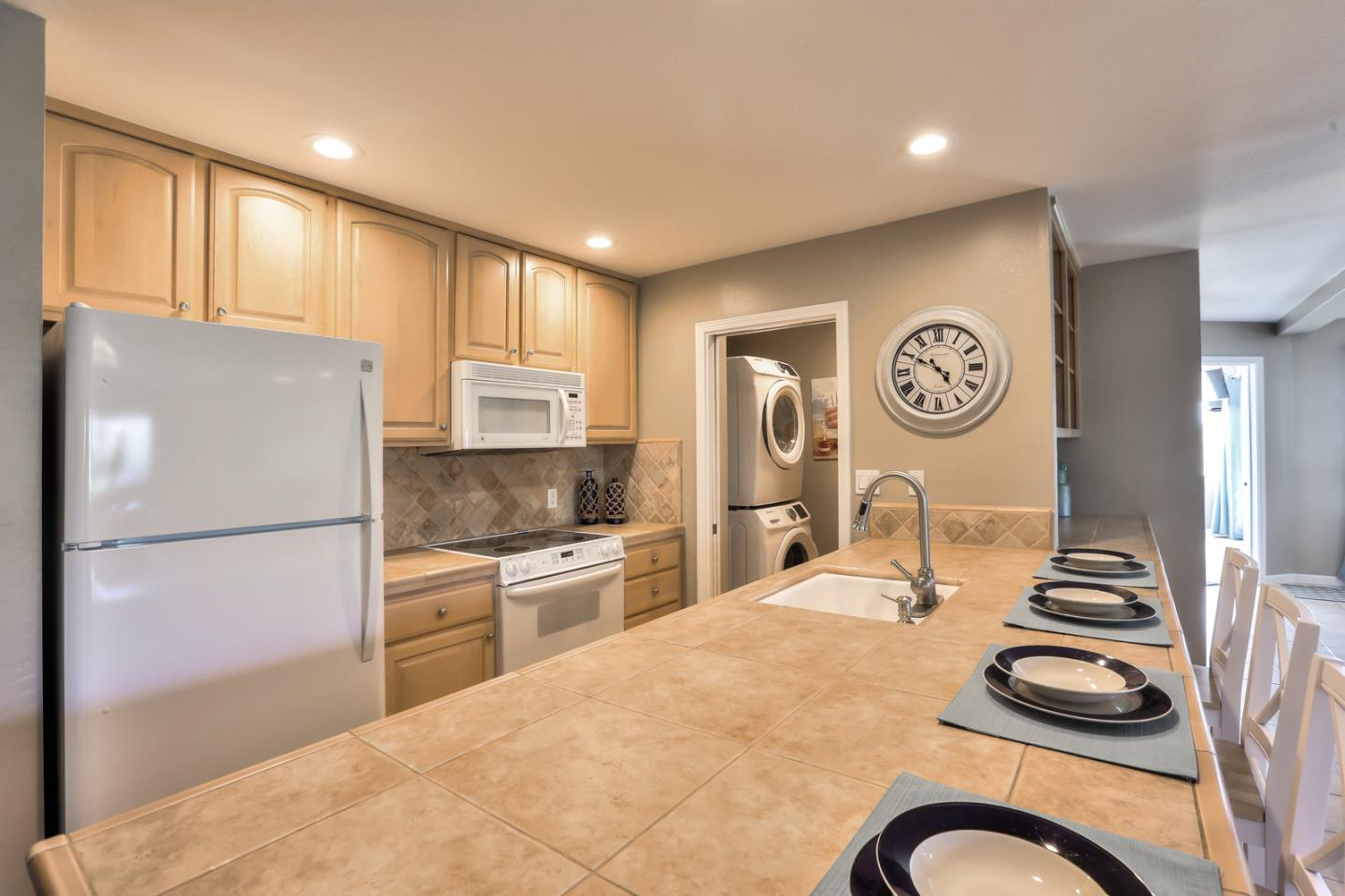 101 Shell Road, Unit 285 Watsonville, CA 95076 - Photo 7 of 27 a kitchen with a refrigerator and a stove top oven