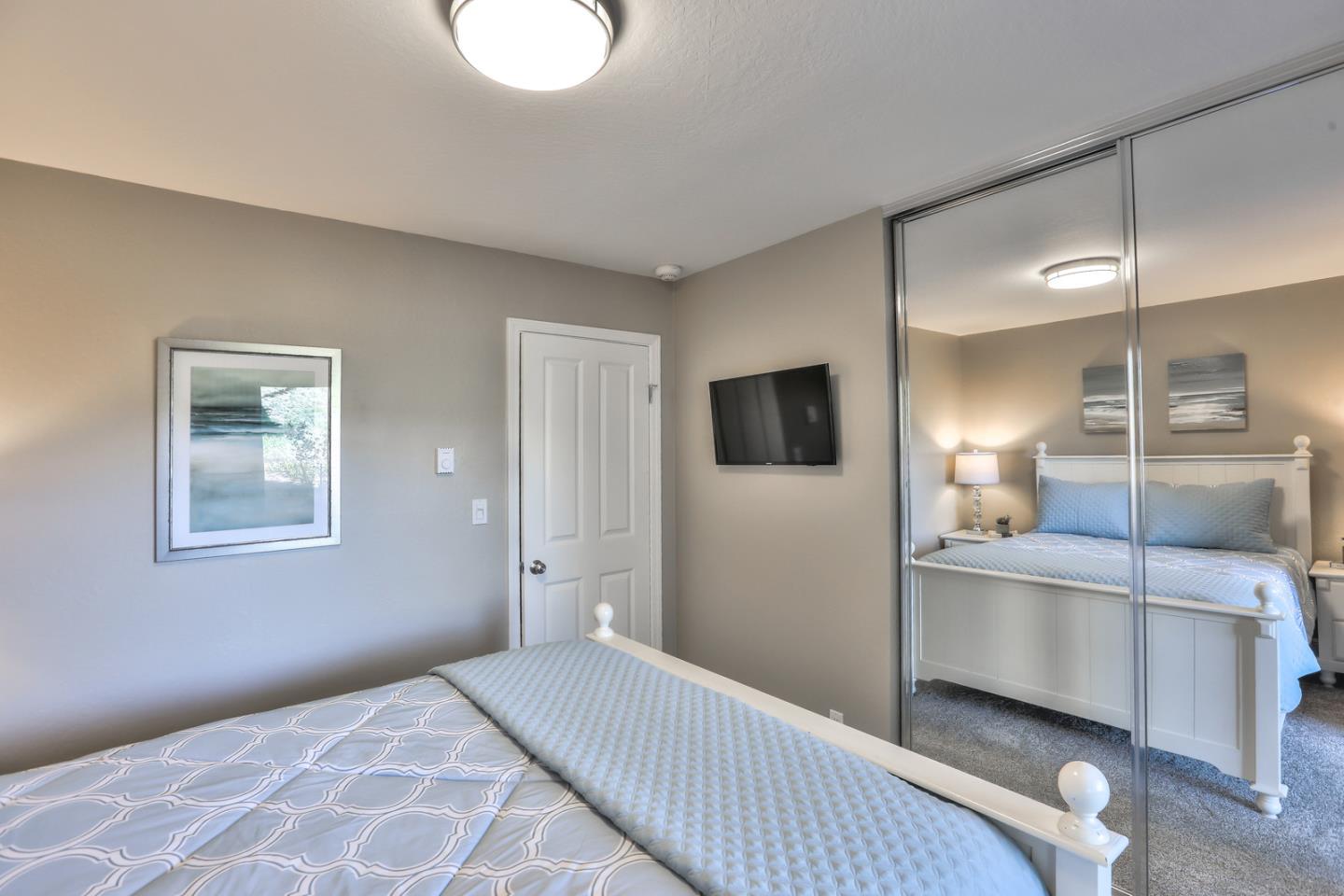 101 Shell Road, Unit 285 Watsonville, CA 95076 - Photo 10 of 27 a bedroom with a bed and a flat screen tv
