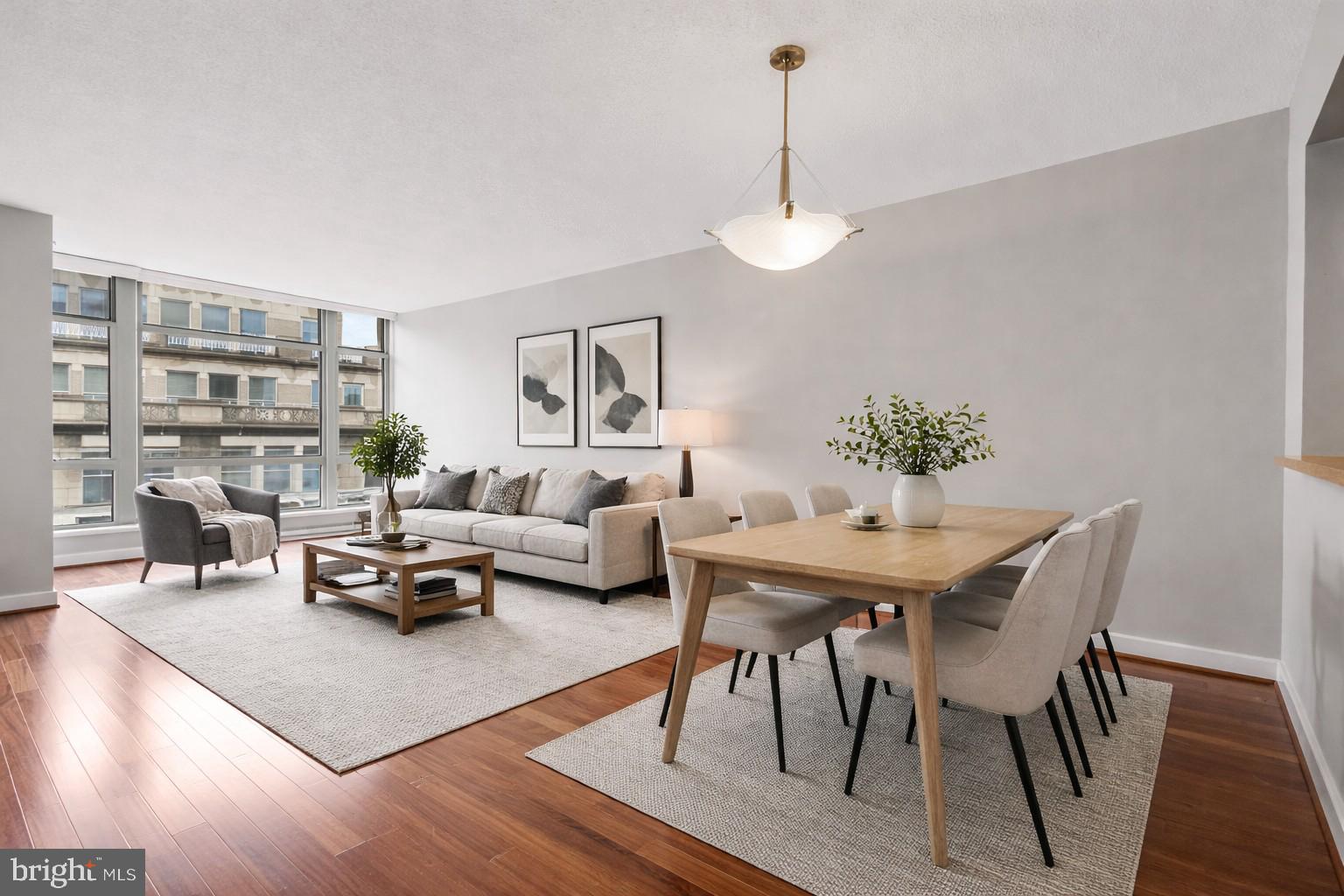 1150 K Street Northwest, Unit 1307 Washington, DC 20005 - Photo 2 of 29 a living room with furniture a rug and a chandelier
