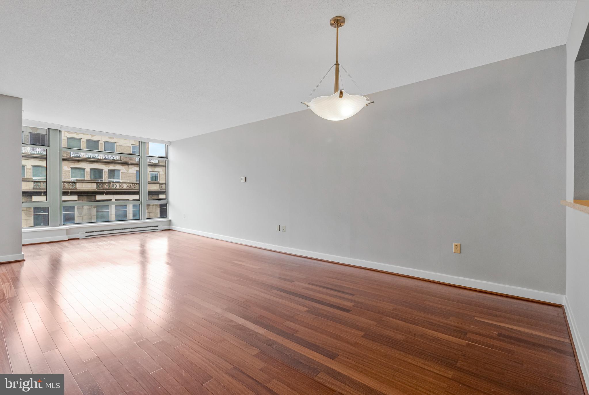 1150 K Street Northwest, Unit 1307 Washington, DC 20005 - Photo 21 of 29 a view of an empty room with window and wooden floor