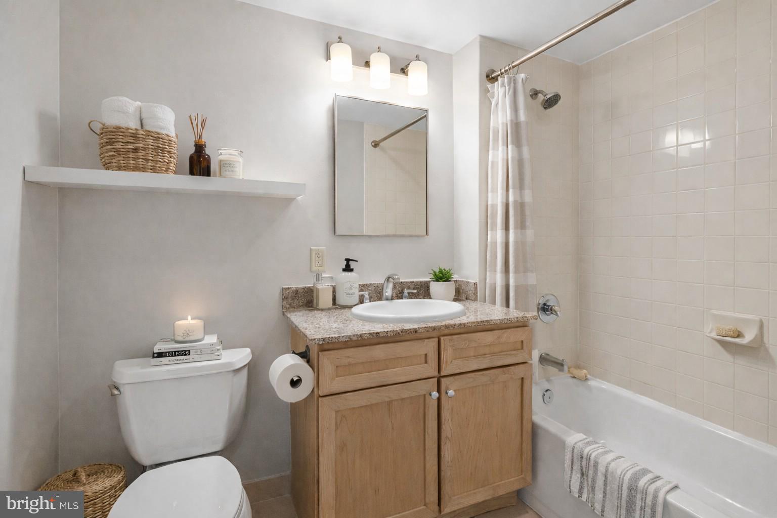 1150 K Street Northwest, Unit 1307 Washington, DC 20005 - Photo 5 of 29 a bathroom with a sink a toilet and shower