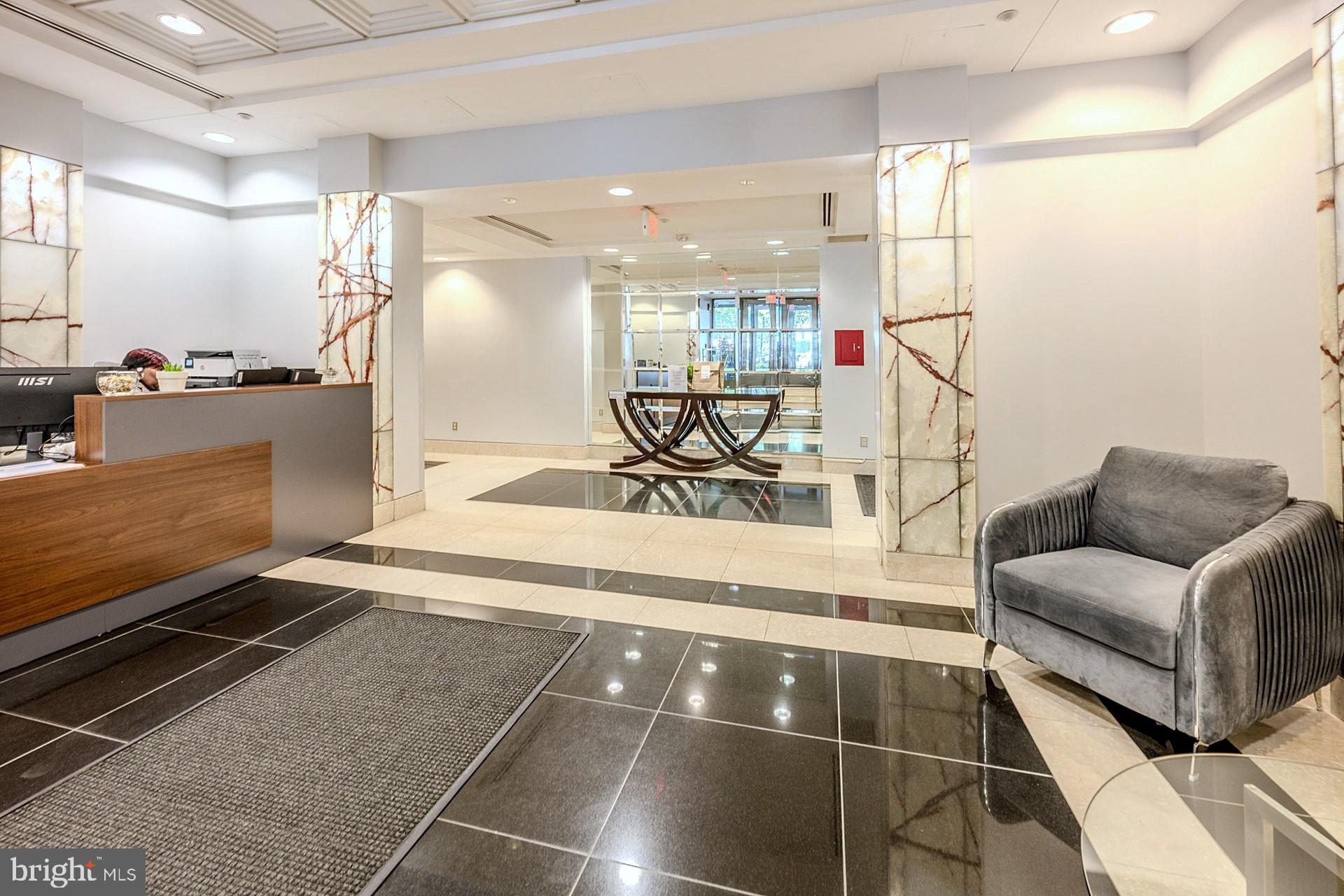 1150 K Street Northwest, Unit 1307 Washington, DC 20005 - Photo 9 of 29 a living room with a couch and a coffee table