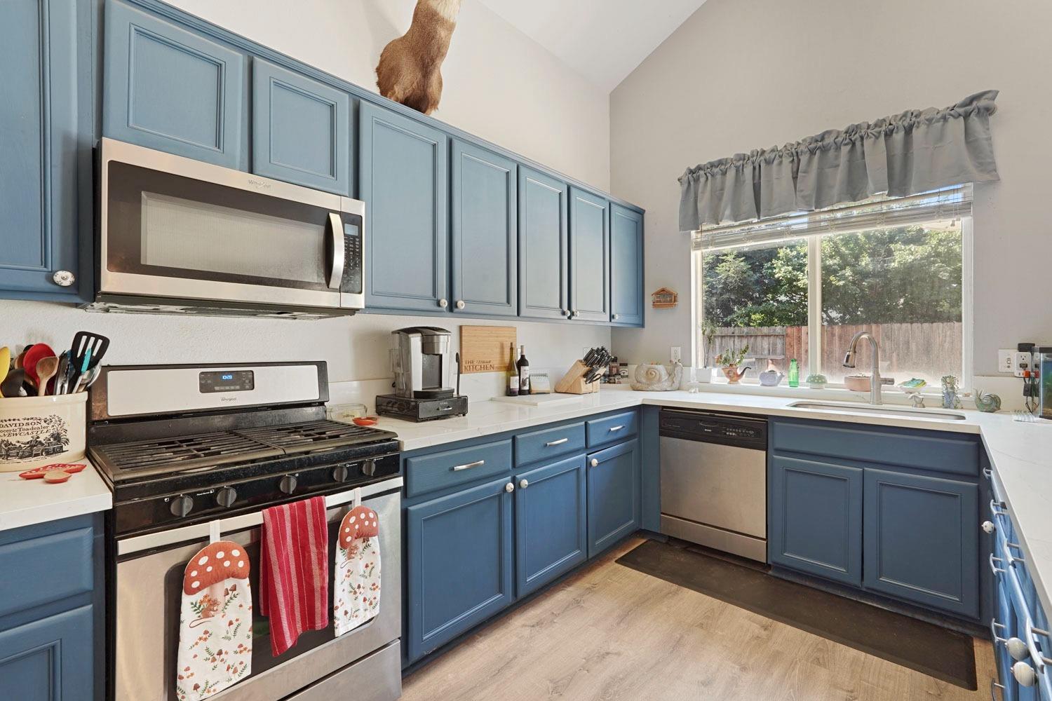 924 Dancer Way Turlock, CA 95382 - Photo 12 of 42 a kitchen with stainless steel appliances granite countertop a stove a sink and a microwave
