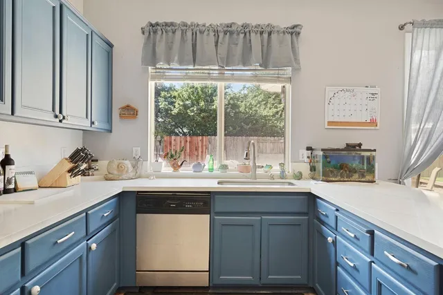 a kitchen with a sink and cabinets