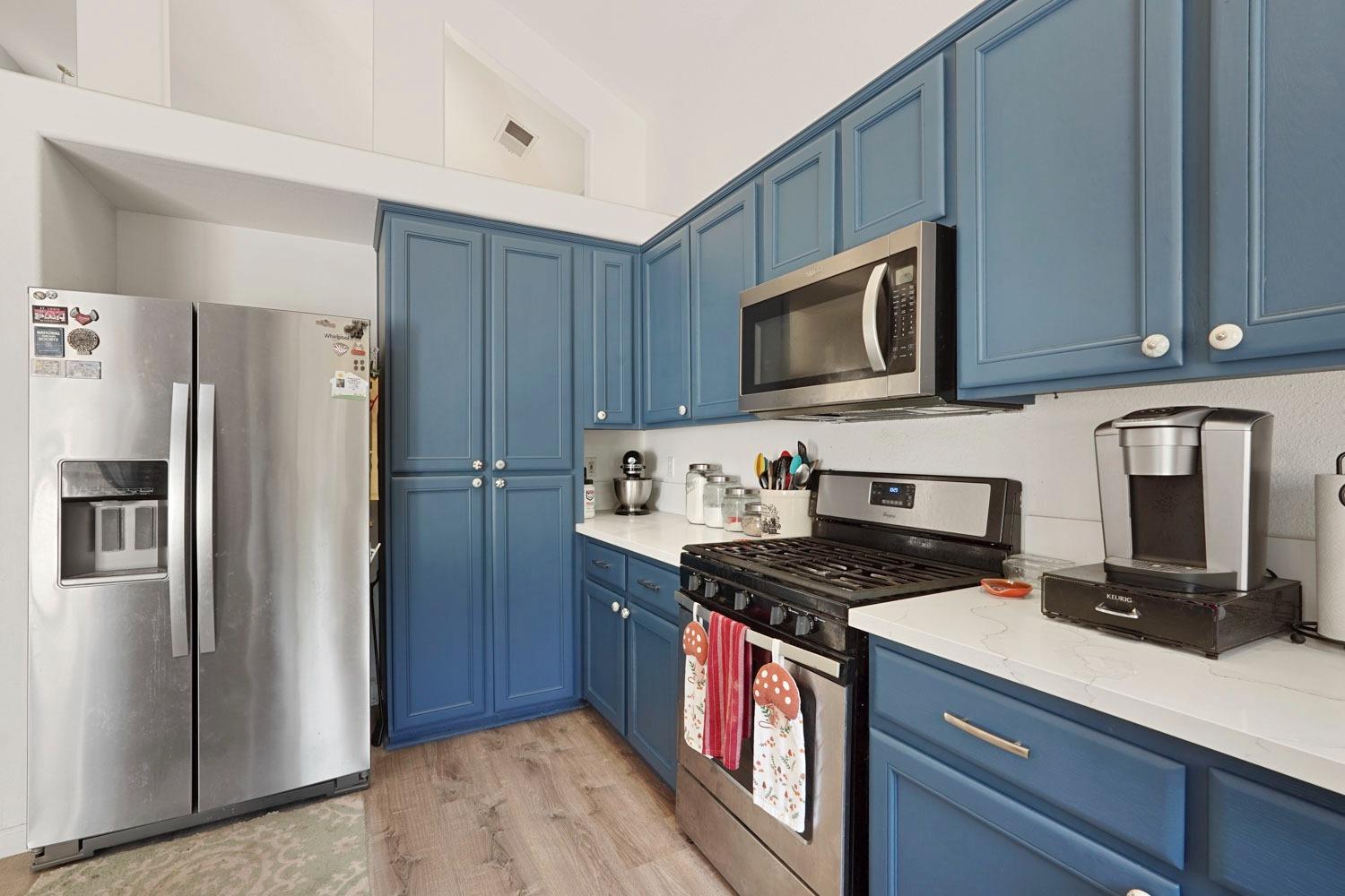 924 Dancer Way Turlock, CA 95382 - Photo 14 of 42 a kitchen with granite countertop a refrigerator stove and microwave