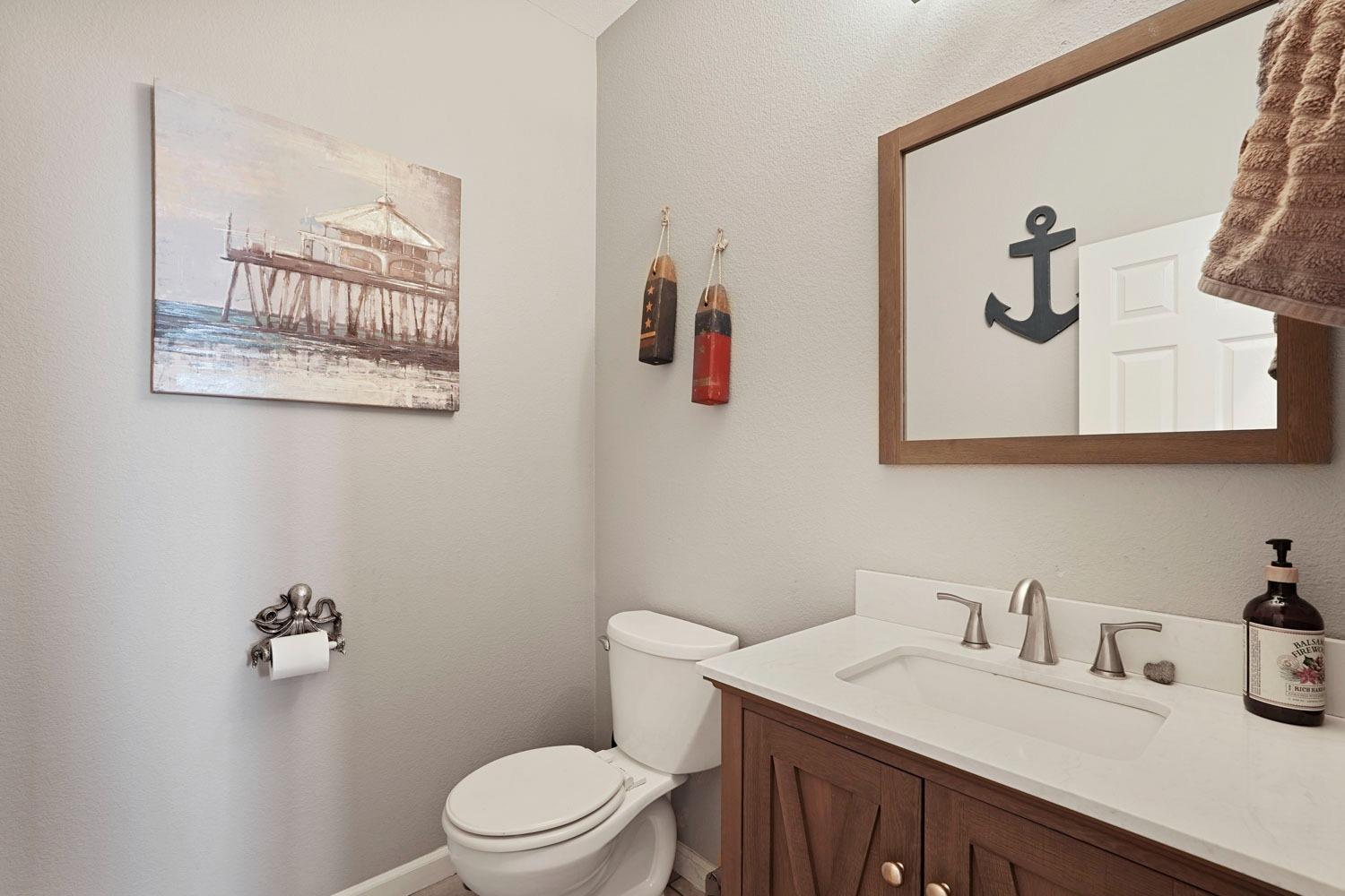 924 Dancer Way Turlock, CA 95382 - Photo 17 of 42 a bathroom with a granite countertop sink mirror and toilet