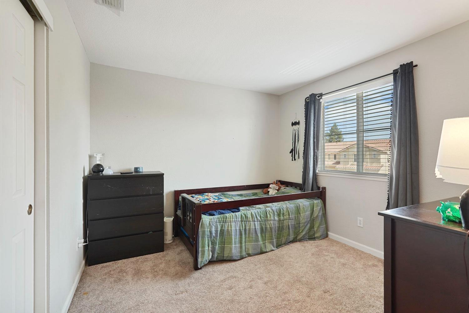 924 Dancer Way Turlock, CA 95382 - Photo 22 of 42 a room with a bed and a window