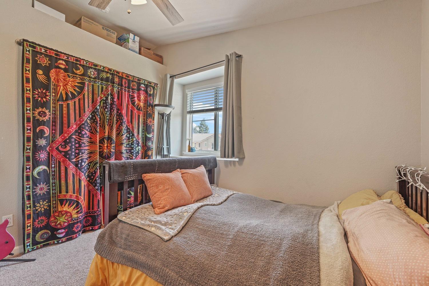 924 Dancer Way Turlock, CA 95382 - Photo 25 of 42 a bedroom with a bed and a painting on the wall