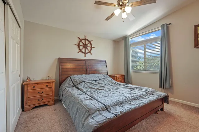 a bedroom with a bed dresser and a window