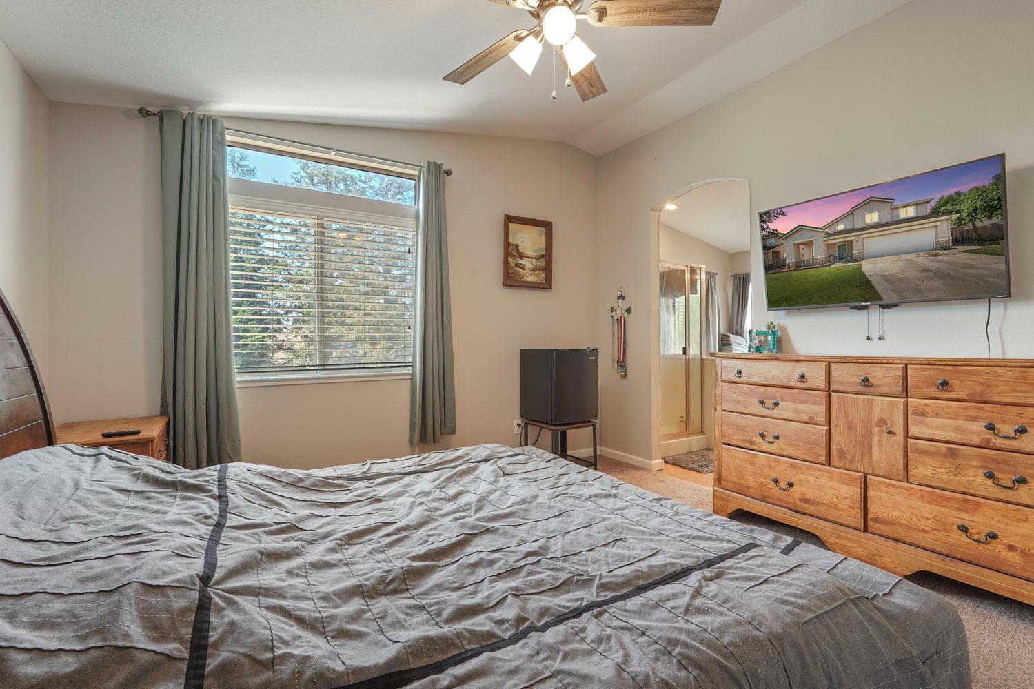 924 Dancer Way Turlock, CA 95382 - Photo 28 of 42 a bedroom with a bed and a flat screen tv