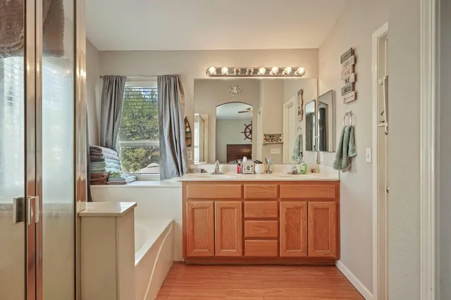 a bathroom with a double vanity sink and a mirror