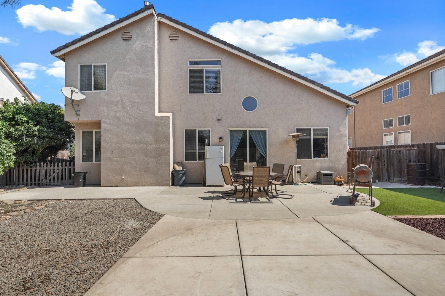 924 Dancer Way Turlock, CA 95382 - Photo 33 of 42 a view of a patio with a table and chairs and potted plants