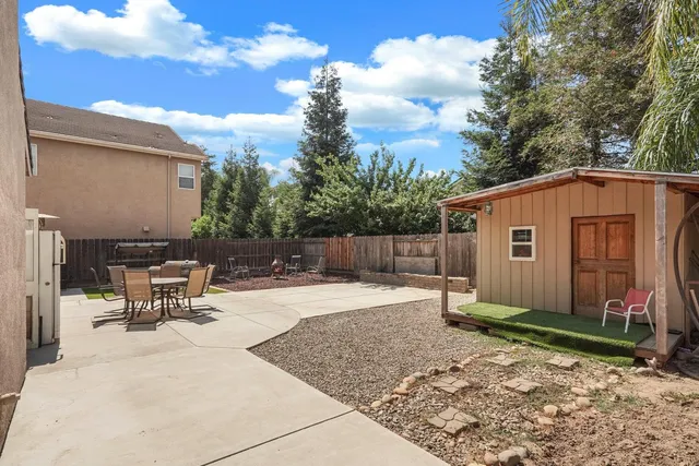 a backyard of a house with yard and outdoor seating