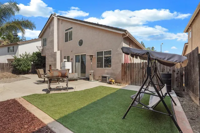 a house view with a sitting space and garden