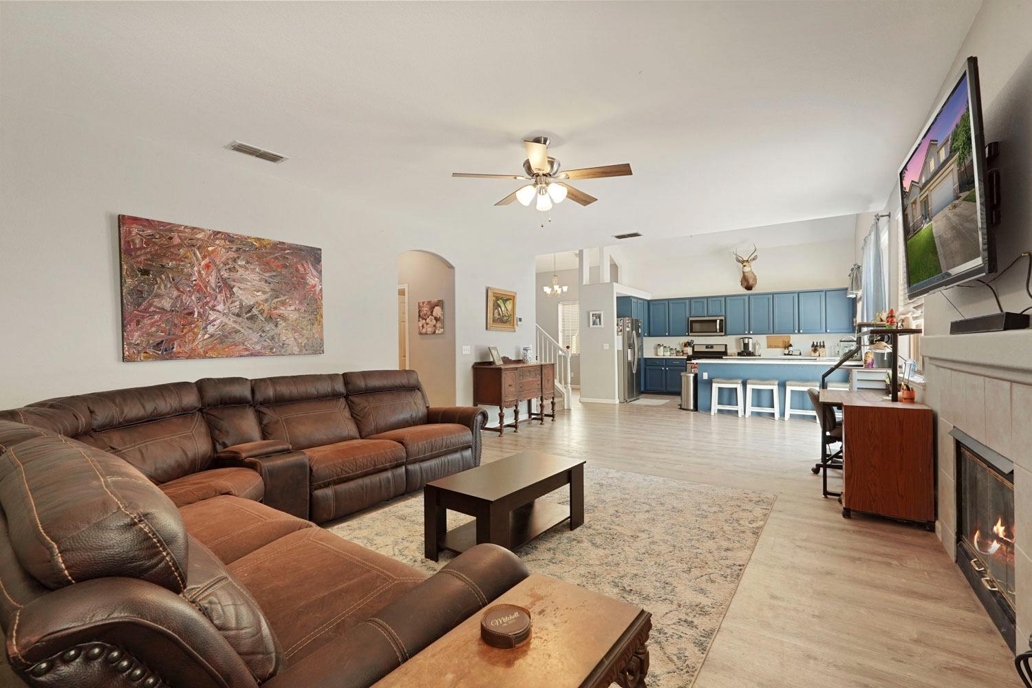 924 Dancer Way Turlock, CA 95382 - Photo 9 of 42 a living room with furniture a flat screen tv and kitchen view