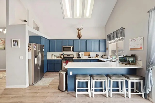 a large kitchen with a table and chairs