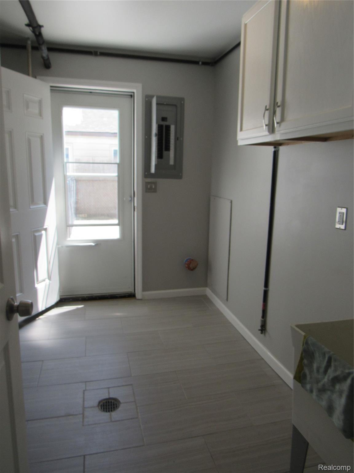 6764 Harding Street Taylor, MI 48180 - Photo 26 of 37 Spacious laundry leads to the side patio/fenced in Driveway!!