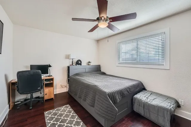 a bedroom with a bed and a chair