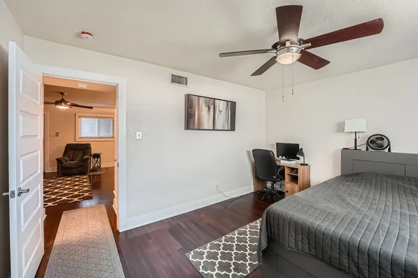 a bedroom with a bed and a chandelier