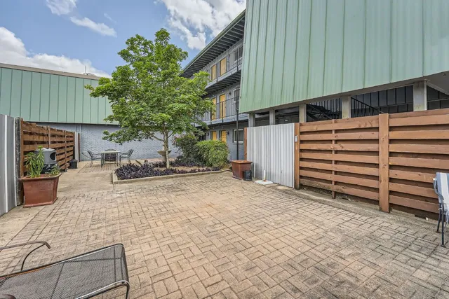 a view of house with backyard and sitting area