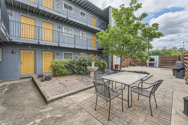 a view of a patio with table and chairs