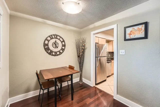 a view of a dining room with furniture and wooden floor