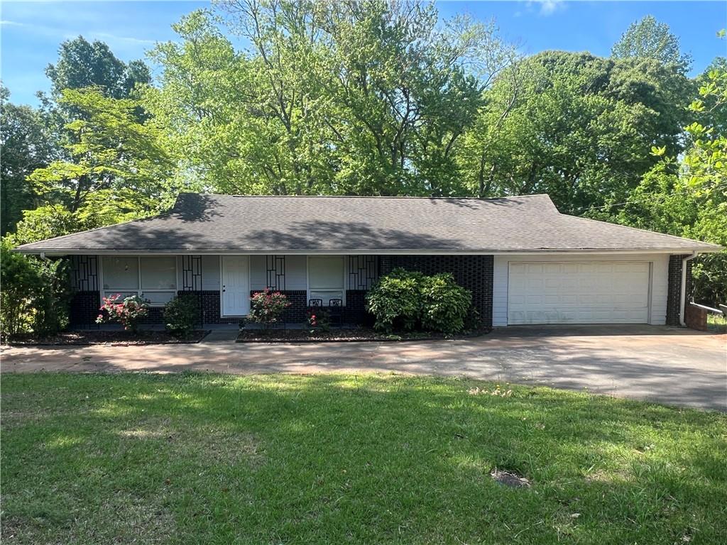 1379 Pair Road Southwest Marietta, GA 30008 - Photo 1 of 1 a view of a house with a yard and garage
