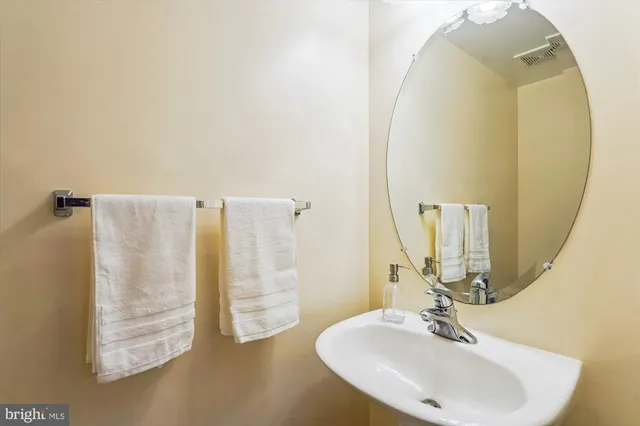 a view of hallway with stairs and a refrigerator