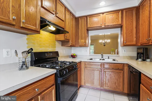 a kitchen with a sink a stove and cabinets