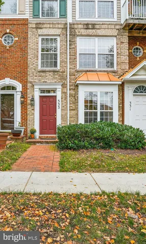 a view of a brick house with a yard