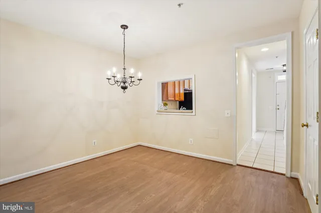 a view of a room with wooden floor and ceiling fan