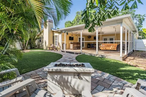 a front view of a house with a garden and patio