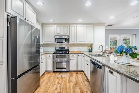 a kitchen with a sink stainless steel appliances and cabinets