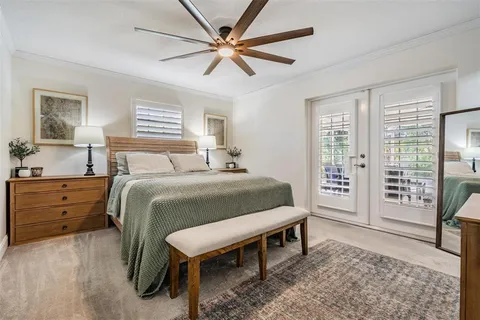 a spacious bedroom with a bed and a table in it