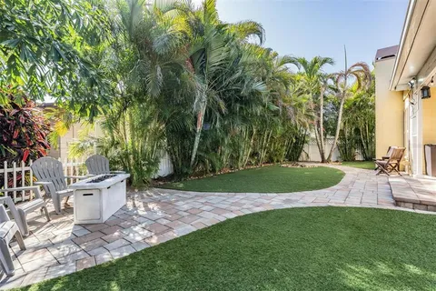 a view of a yard with plants and trees