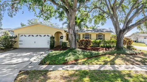 a view of a house with a tree in the background