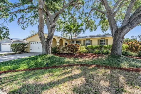 a view of a house with a tree in the background