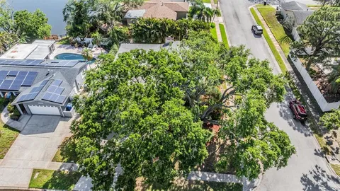 an aerial view of a house with a yard and sitting area