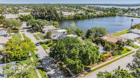 an aerial view of a house with a lake view