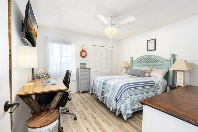a bedroom with two beds and a flat screen tv