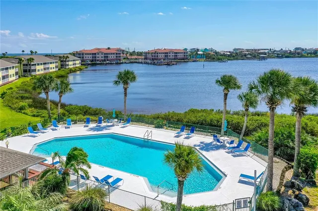 a view of swimming pool with outdoor seating and city view
