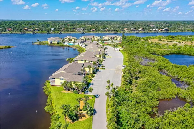 an aerial view of a house with a ocean view