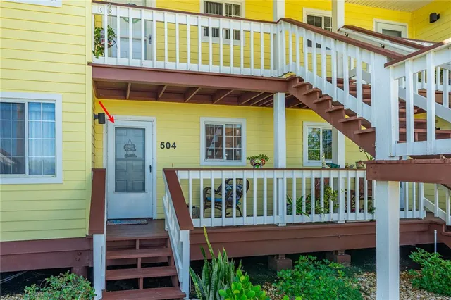 a view of a wooden house with a small yard