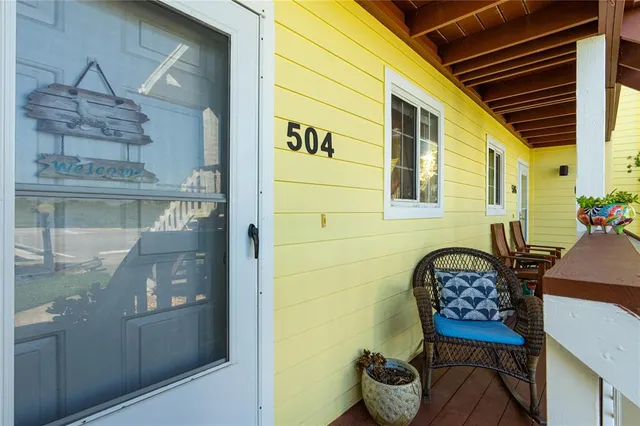 a front view of a house with outdoor seating and a potted plant