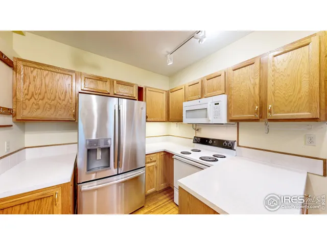 a kitchen with stainless steel appliances granite countertop a refrigerator sink stove and microwave