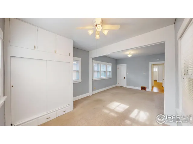 a room with a bed and wooden floor