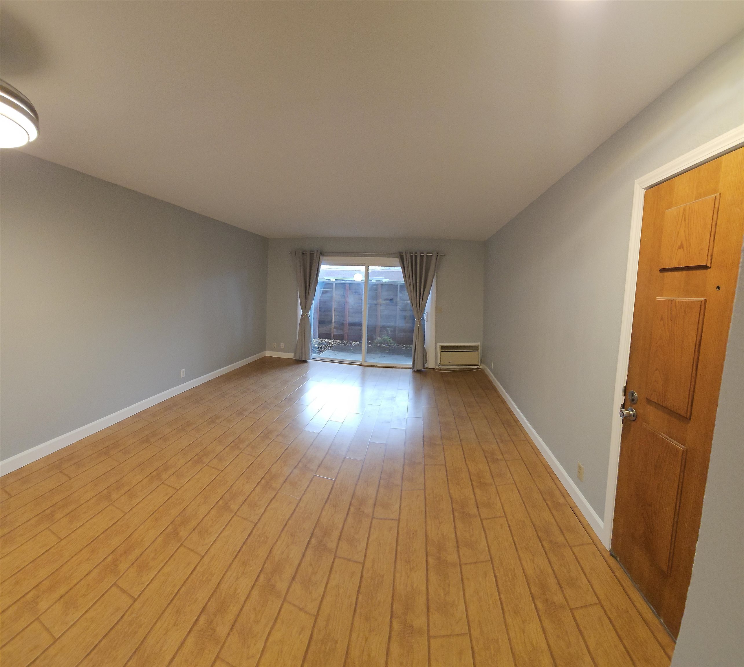 4081 Clayton Road, Unit 122 Concord, CA 94521 - Photo 18 of 29 an empty room with wooden floor and windows