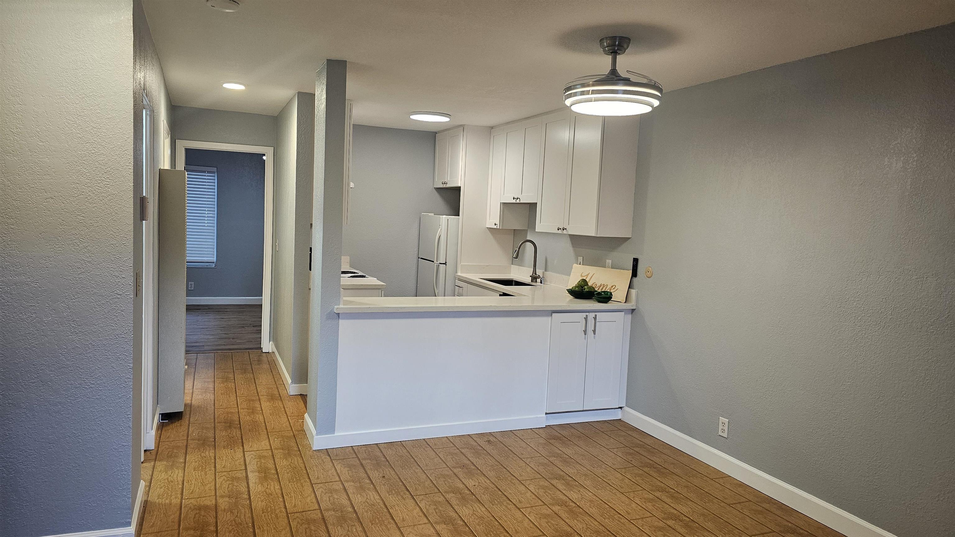 4081 Clayton Road, Unit 122 Concord, CA 94521 - Photo 22 of 29 a hallway with a sink and chandelier