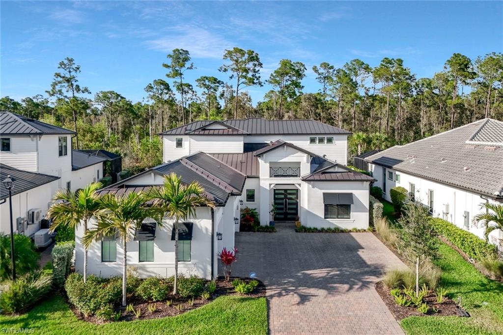 16249 Verilyn Circle Naples, FL 34110 - Photo 1 of 48 a front view of a house with a garden