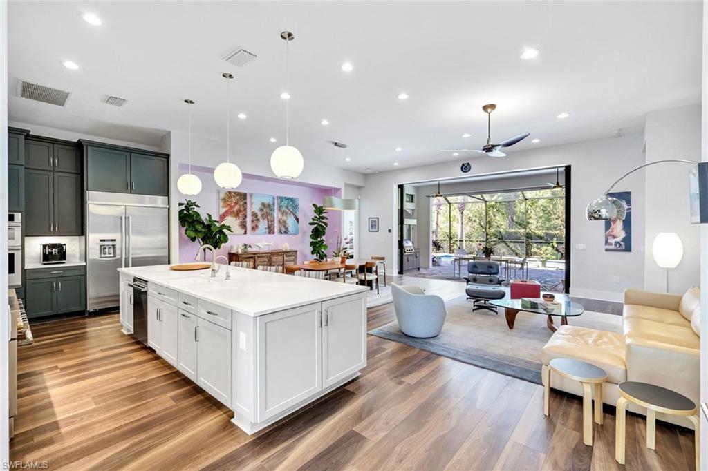 16249 Verilyn Circle Naples, FL 34110 - Photo 15 of 48 a large kitchen with kitchen island a large island in the center